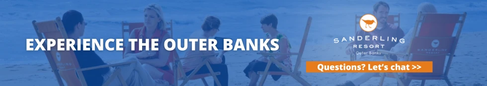 An image ad for Sanderling Resort showing people sitting on beach chairs with text "EXPERIENCE THE OUTER BANKS" and a "Questions? Let's chat >>" button.
